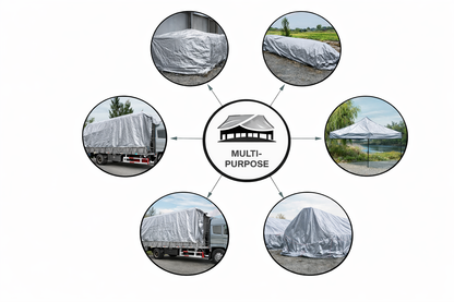 Silver heavy-duty tarp covering large outdoor equipment and materials
