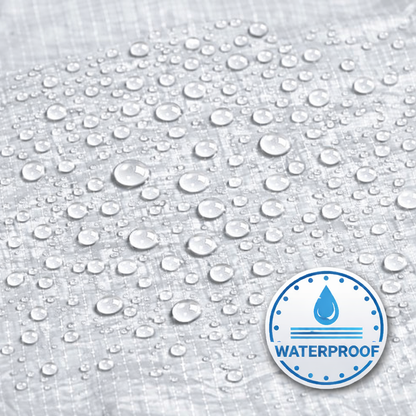 White heavy-duty tarp covering large outdoor equipment and materials
