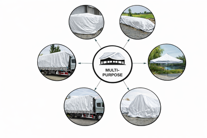 White heavy-duty tarp covering large outdoor equipment and materials
